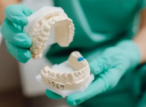 Dentist Showing Cosmetic Teeth Molds